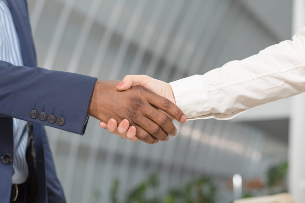 two people shaking hands for a commitment